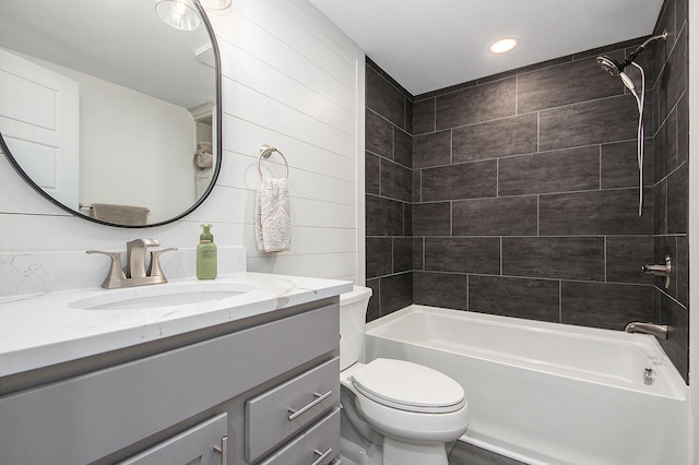 bathroom featuring toilet, shower / bath combination, and vanity