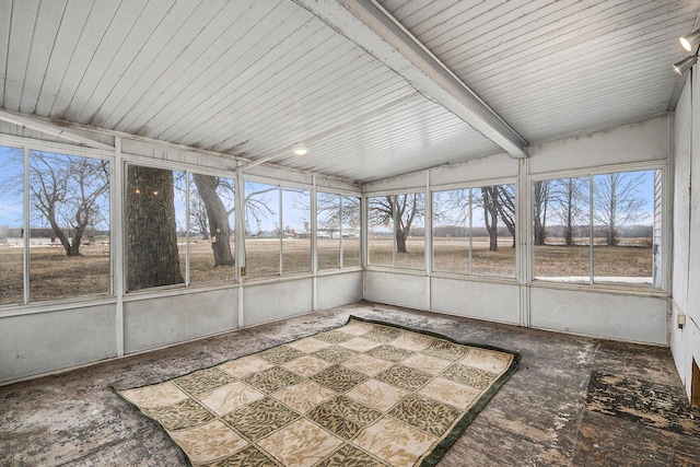 unfurnished sunroom with beam ceiling