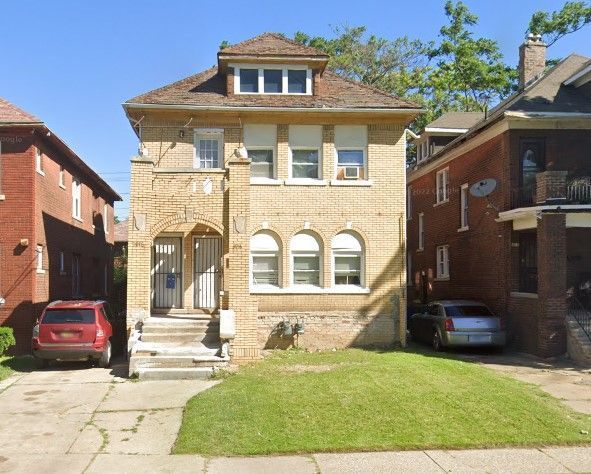 traditional style home with a front yard and brick siding