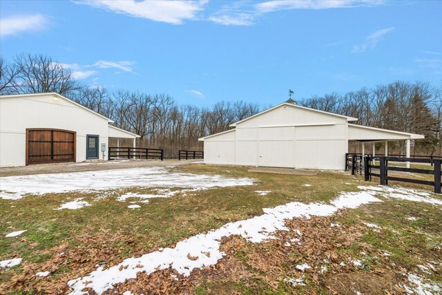 exterior space featuring an outbuilding, a detached garage, and an exterior structure