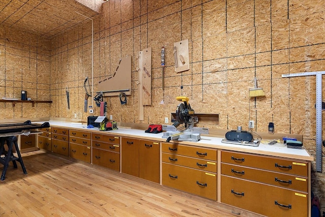 kitchen featuring brown cabinets, light wood finished floors, and light countertops