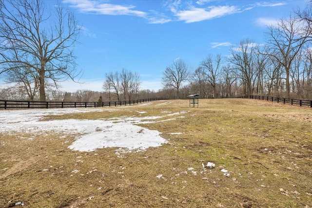 view of yard featuring a rural view and fence