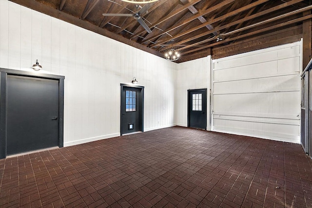 interior space with wooden walls and brick patterned floor