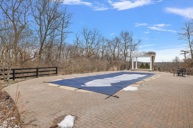 view of swimming pool with a patio area, fence, a fenced in pool, and a pergola