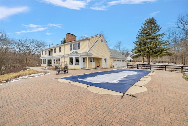 view of swimming pool featuring a patio area, fence, and a fenced in pool