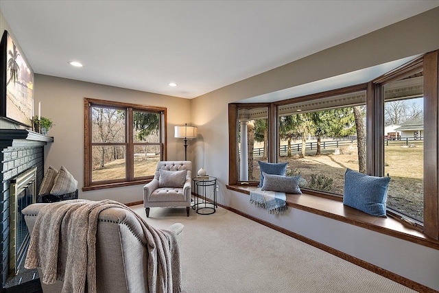 interior space featuring carpet floors, recessed lighting, baseboards, and a brick fireplace
