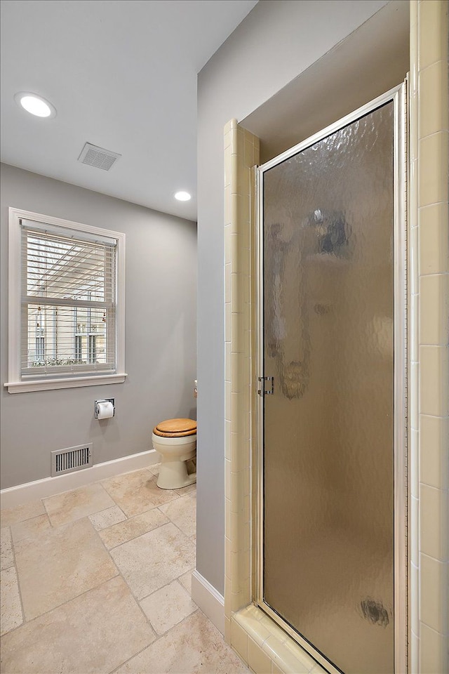 full bathroom featuring baseboards, a stall shower, and visible vents