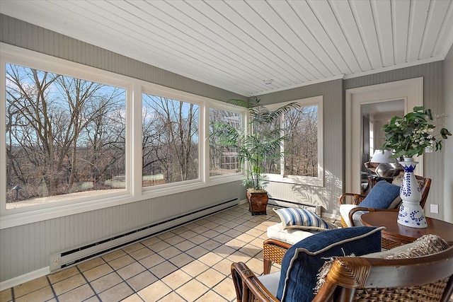 sunroom with tile patterned flooring, baseboard heating, and a healthy amount of sunlight