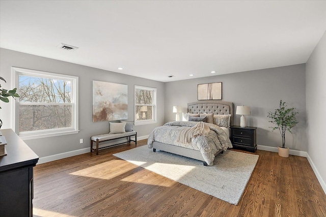 bedroom featuring baseboards, multiple windows, dark wood-style flooring, and visible vents
