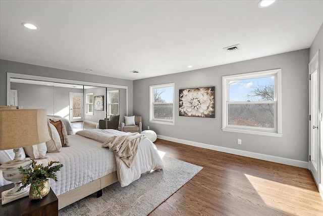 bedroom with recessed lighting, baseboards, visible vents, and wood finished floors