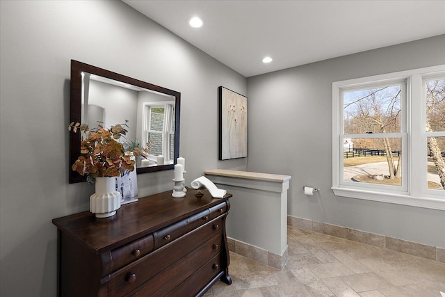 interior space with baseboards, recessed lighting, and stone tile floors
