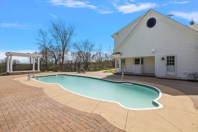 outdoor pool with a pergola and a patio