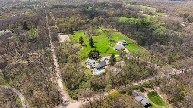 drone / aerial view with a wooded view
