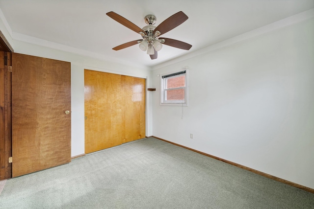 unfurnished bedroom featuring a ceiling fan, carpet, a closet, and baseboards