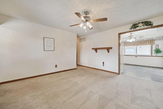 empty room featuring baseboards, a textured ceiling, visible vents, and carpet flooring