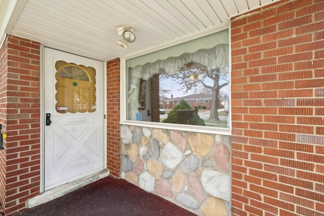 property entrance featuring brick siding