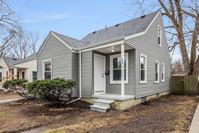 view of front of house featuring fence and roof with shingles