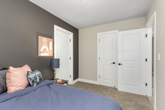 bedroom featuring carpet and baseboards