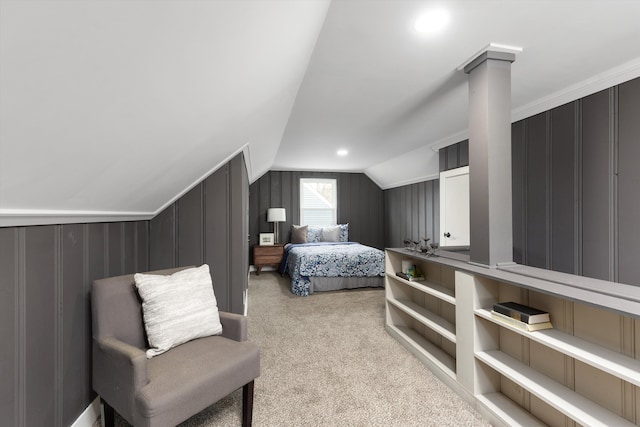 bedroom featuring carpet floors, lofted ceiling, and ornate columns