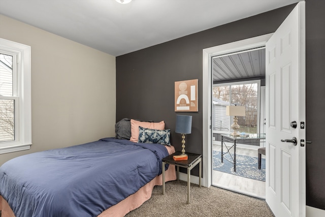 carpeted bedroom with multiple windows