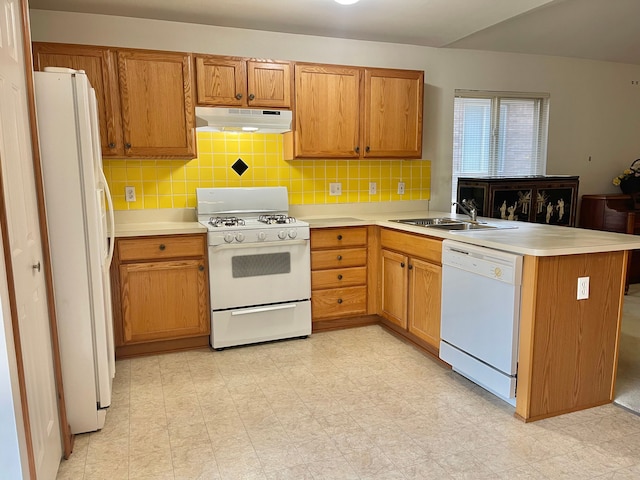 kitchen featuring light floors, a sink, a peninsula, white appliances, and under cabinet range hood