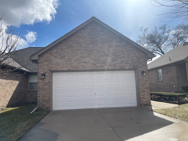 garage featuring concrete driveway