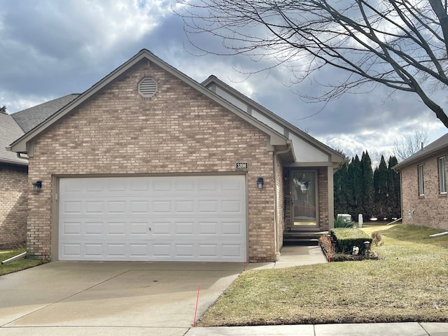 single story home featuring driveway, a front yard, a garage, and brick siding