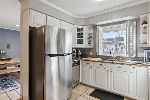 kitchen with crown molding, open shelves, stainless steel appliances, white cabinets, and a sink