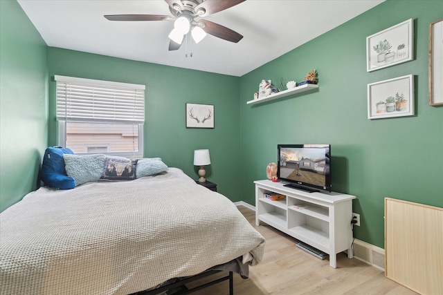 bedroom featuring baseboards, a ceiling fan, and light wood-style floors