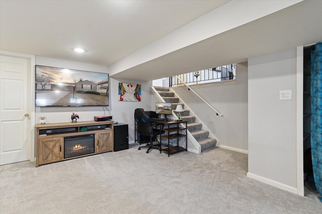 home office with carpet floors, recessed lighting, a glass covered fireplace, and baseboards