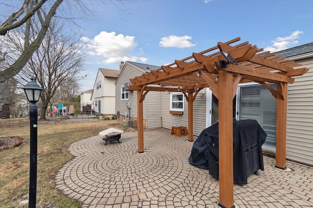 view of patio / terrace featuring an outdoor fire pit, a playground, grilling area, and a pergola