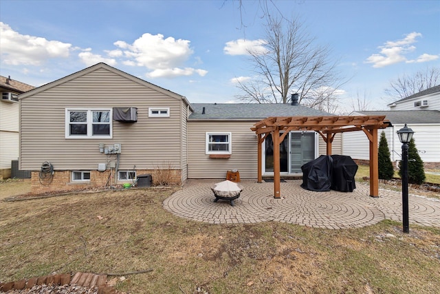 rear view of property with central air condition unit, a patio area, a pergola, and a yard