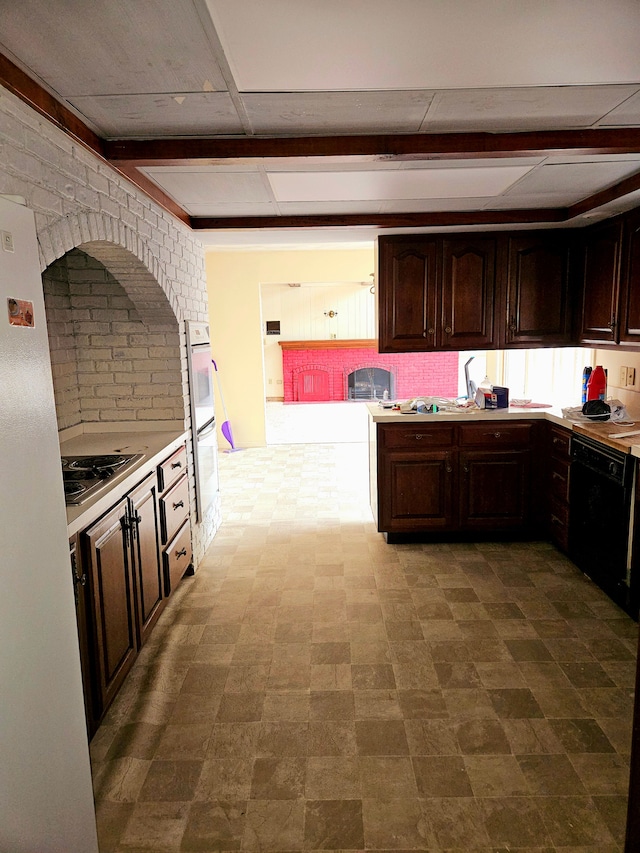 kitchen with dark brown cabinets, white appliances, and light countertops