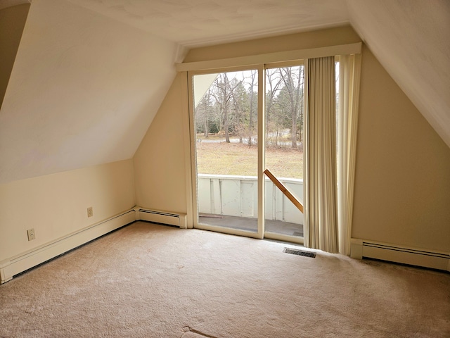 additional living space with lofted ceiling, a baseboard heating unit, visible vents, and carpet flooring