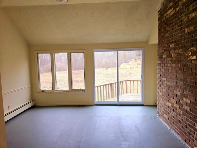 interior space with lofted ceiling, a healthy amount of sunlight, and baseboard heating