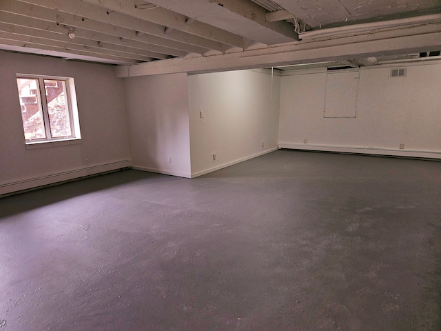 basement featuring a baseboard radiator and visible vents