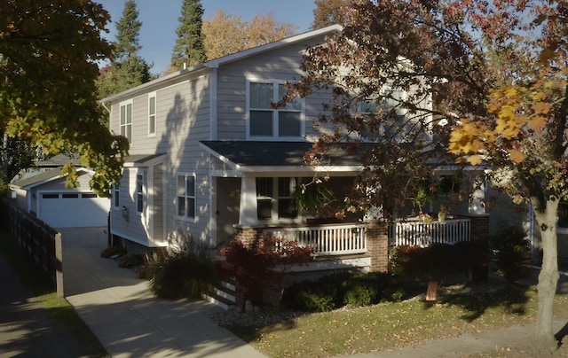 view of front of home with covered porch, concrete driveway, and an outdoor structure