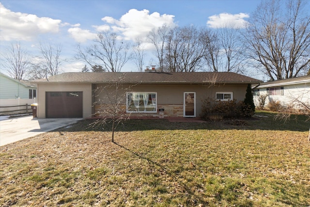 view of front of property featuring a garage, concrete driveway, and a front lawn