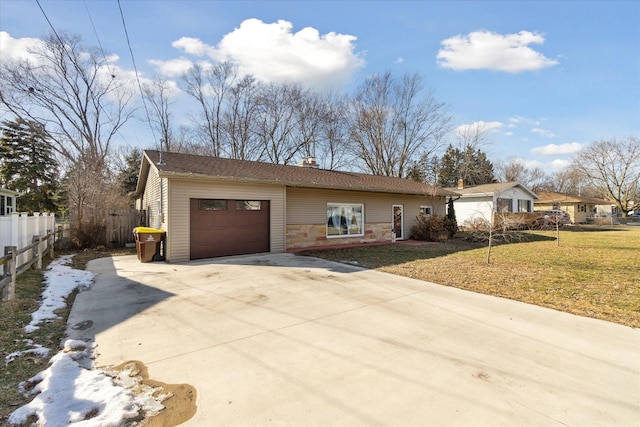 ranch-style house with a front lawn, driveway, an attached garage, and fence