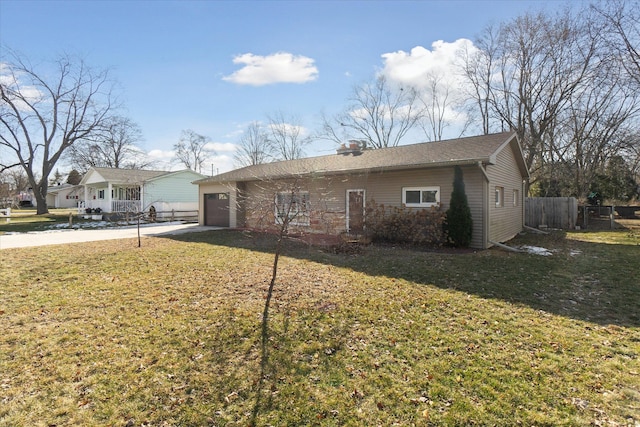 ranch-style house featuring a garage, concrete driveway, a front yard, and fence