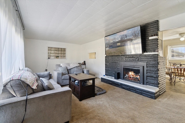 living room with a fireplace and carpet flooring