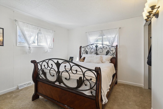 bedroom featuring carpet, visible vents, and multiple windows