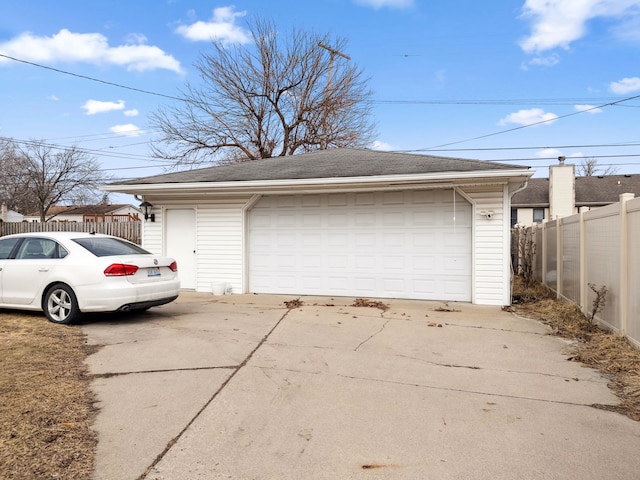 detached garage featuring fence