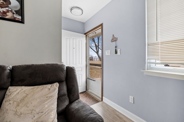 interior space with wood finished floors and baseboards