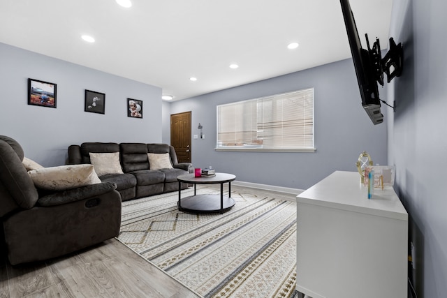 living area featuring light wood-type flooring, baseboards, and recessed lighting