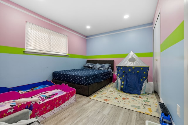 bedroom with wood finished floors and recessed lighting