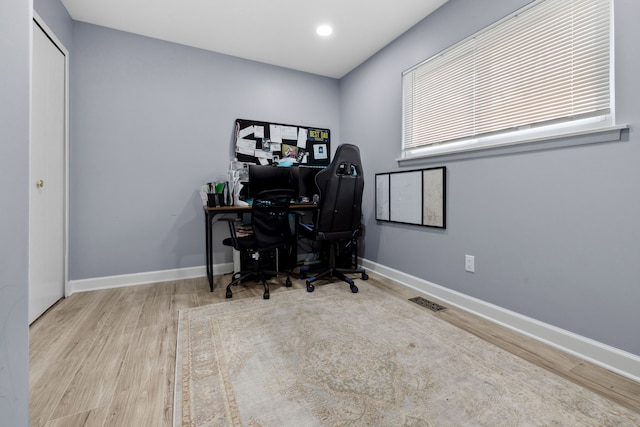 home office featuring visible vents, baseboards, wood finished floors, and recessed lighting