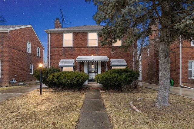 traditional home with brick siding and a chimney