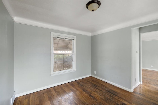 unfurnished room with ornamental molding, hardwood / wood-style floors, and baseboards