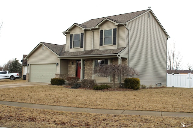 traditional-style home with driveway, a garage, a shingled roof, fence, and brick siding